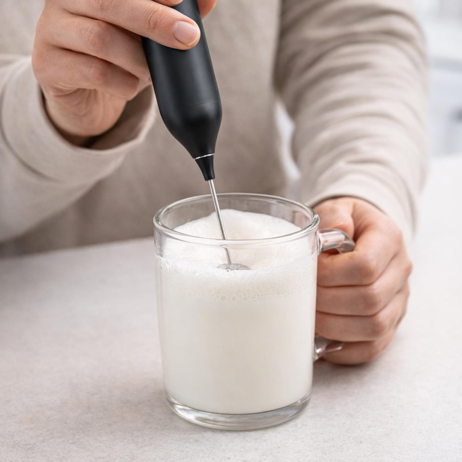 Handheld milk frother in use