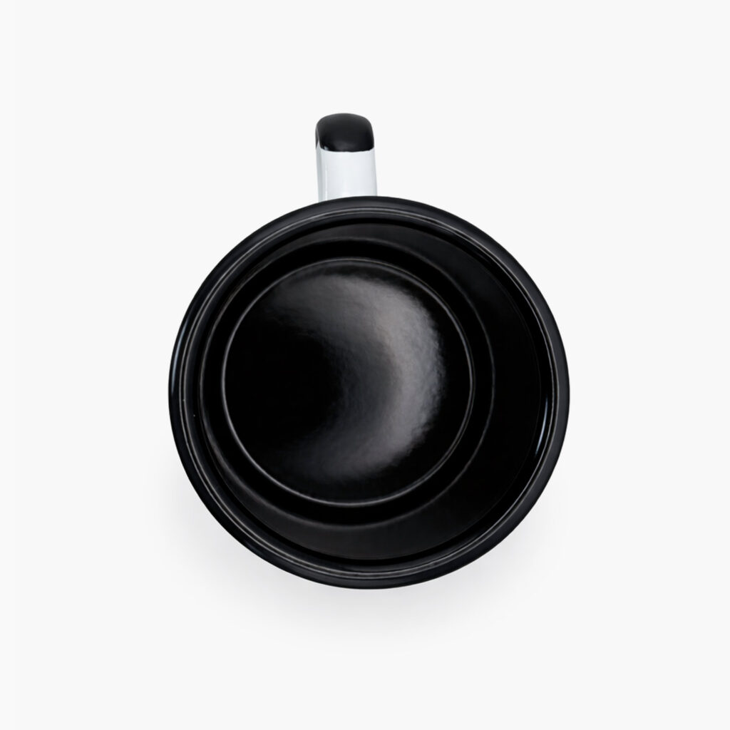 Top view of Coffee for a Change white enamel camping mug with black interior and handle