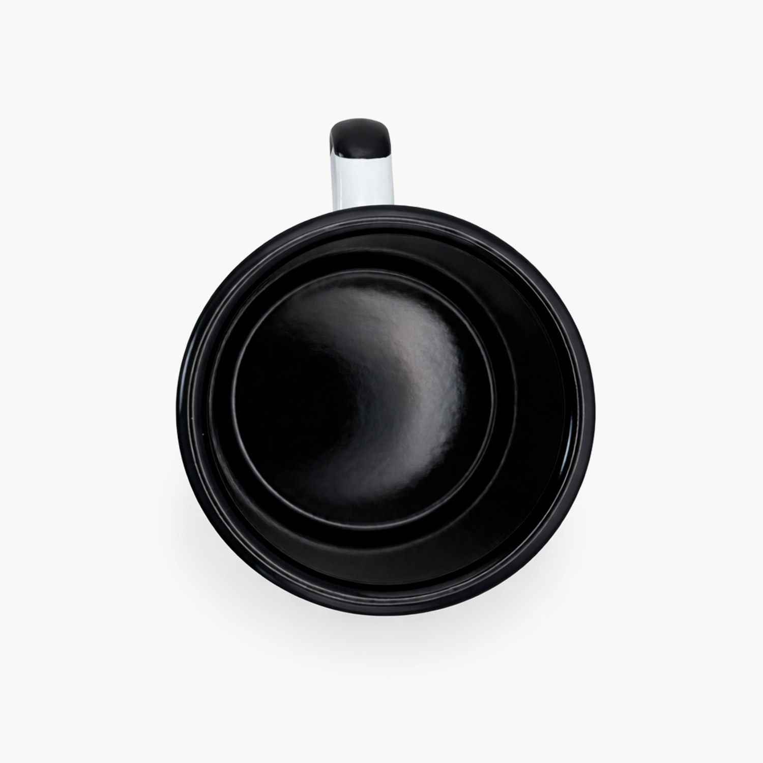 Top view of Coffee for a Change white enamel camping mug with black interior and handle
