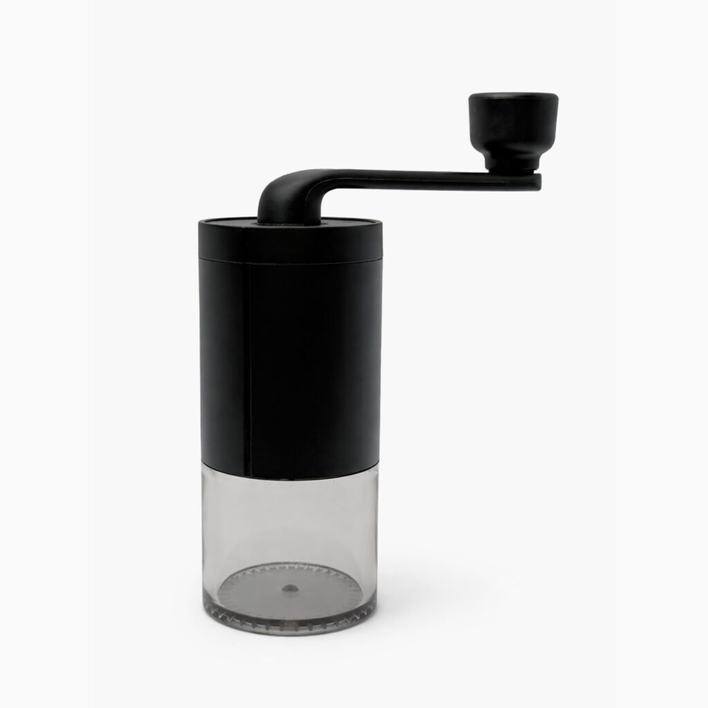 Manual coffee grinder with matte black body and clear grounds container