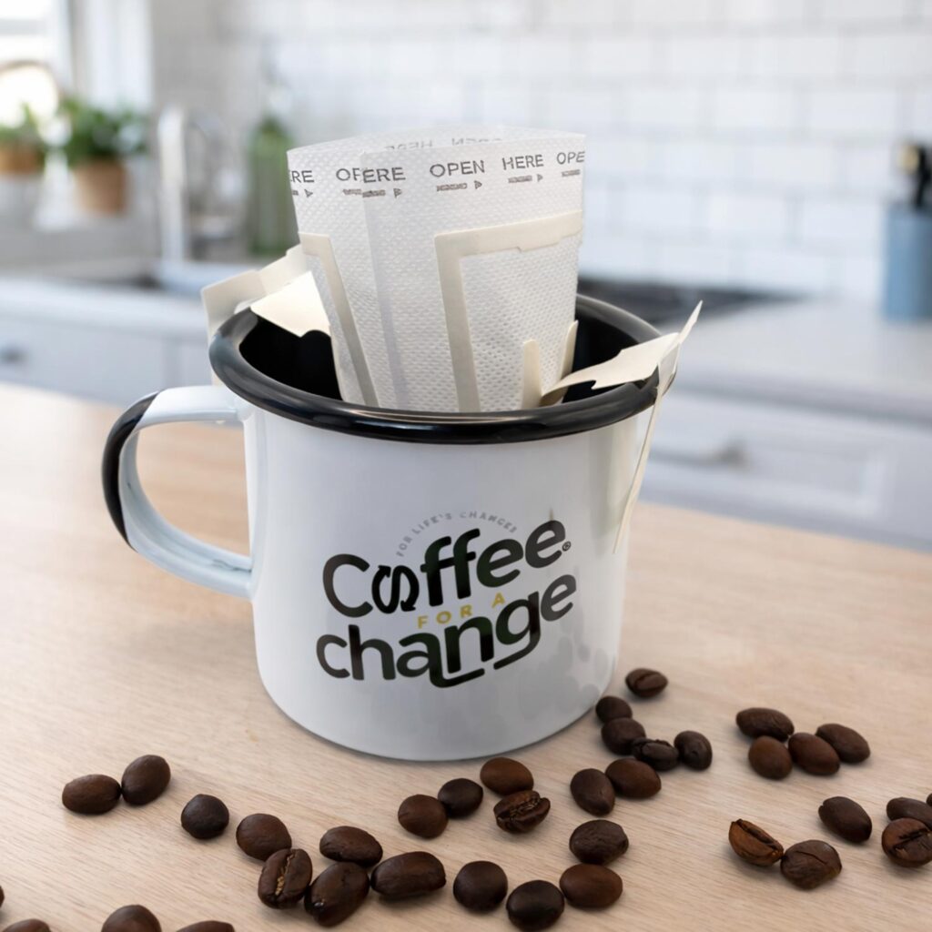 Hanging ear coffee filter brewing inside enamel mug, single serve pour over coffee filter in cup